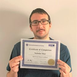 Male Scrum Master holding certificate