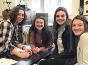 four young female engineers smiling