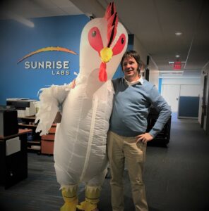 Person in Chicken costum and man hugging