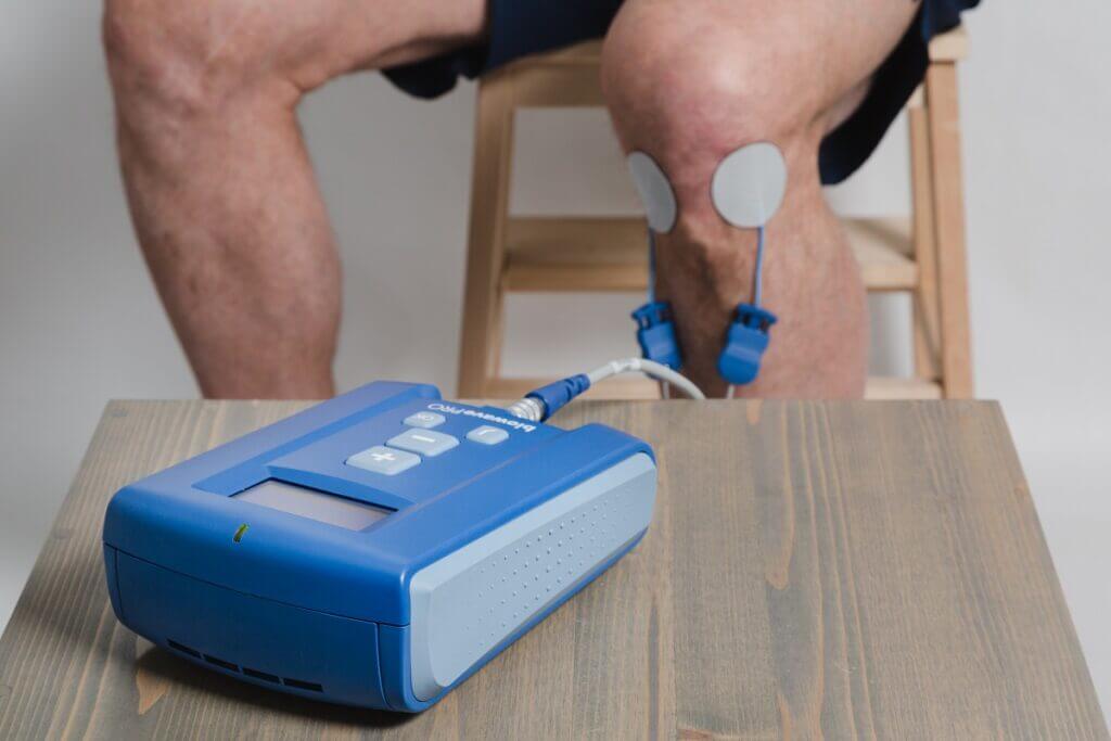 neuromodulation therapy device attached to a knee