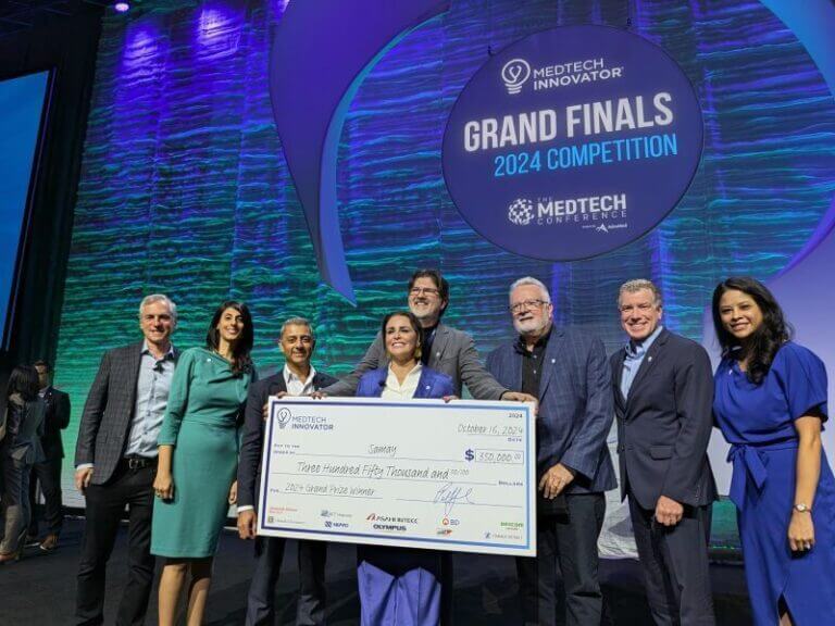 Samay accepting prize check at MedTech Innovator