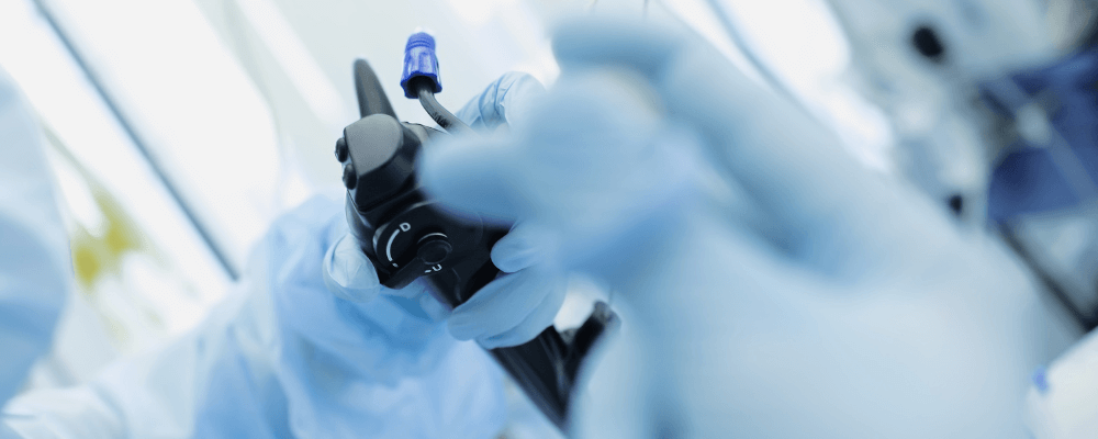 Medical device being held by gloved hands